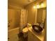Bathroom with a unique bowl sink, decorative light fixture, and shower with patterned curtain at 903 Creek Bottom Rd, Loganville, GA 30052
