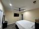 Bedroom with ceiling fan, TV, wood-look floors, neutral paint colors, and window with blinds at 903 Creek Bottom Rd, Loganville, GA 30052