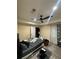 Bedroom with ceiling fan, gray walls, and gray laminate flooring; features window and closet at 903 Creek Bottom Rd, Loganville, GA 30052