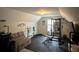Home exercise room with weightlifting equipment, bench, and a comfortable couch at 903 Creek Bottom Rd, Loganville, GA 30052