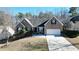 Charming single-Gathering home boasts a well-manicured lawn, a two-car garage, and classic brick facade at 903 Creek Bottom Rd, Loganville, GA 30052