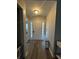 Inviting foyer with hardwood floors, storage bench, and natural light streaming through the door at 903 Creek Bottom Rd, Loganville, GA 30052