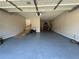 Spacious garage with epoxy flooring, ramp, and ample storage space for vehicles and equipment at 903 Creek Bottom Rd, Loganville, GA 30052