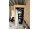 Stacked washer and dryer set in an outdoor closet with a curtain cover at 903 Creek Bottom Rd, Loganville, GA 30052