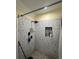 Tiled shower featuring mosaic tile design and a built-in niche for storage at 903 Creek Bottom Rd, Loganville, GA 30052