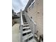 Wooden staircase leading to the home's entrance with white railings and grey steps at 903 Creek Bottom Rd, Loganville, GA 30052