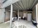 Storage space under the deck with concrete flooring, white table and chairs, and utilities at 903 Creek Bottom Rd, Loganville, GA 30052