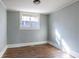 Cozy bedroom with neutral paint, a large window, and laminate flooring at 1126 Indale Sw Pl, Atlanta, GA 30310