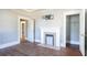 Room with hardwood floors, a decorative fireplace, and doorways to other rooms at 1126 Indale Sw Pl, Atlanta, GA 30310