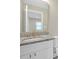 Modern bathroom vanity featuring granite countertop and a large mirror at 1729 Spring Ne St, Conyers, GA 30012