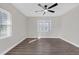Large bedroom painted light gray with vinyl wood floors, ceiling fan, and two large windows at 1729 Spring Ne St, Conyers, GA 30012