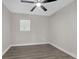 This light gray bedroom has vinyl floors, one window and a modern ceiling fan at 1729 Spring Ne St, Conyers, GA 30012
