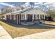 Charming brick home featuring a covered front porch with classic columns at 1729 Spring Ne St, Conyers, GA 30012
