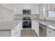 Beautiful kitchen features granite countertops, white cabinets and stainless steel appliances at 1729 Spring Ne St, Conyers, GA 30012