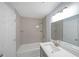 Updated bathroom features a shower-over-tub and neutral colored tile and a gray vanity at 243 Howell Sw Ter, Atlanta, GA 30331