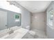 Updated bathroom with a walk-in shower, marble countertops, and light-colored tile at 243 Howell Sw Ter, Atlanta, GA 30331