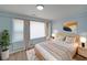 Serene bedroom features blue walls, a large window and comfortable bed at 243 Howell Sw Ter, Atlanta, GA 30331