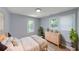 Inviting bedroom featuring neutral colors, a large window, and plush bedding for comfort at 243 Howell Sw Ter, Atlanta, GA 30331
