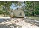 Charming single-story house with green trim, surrounded by mature trees at 243 Howell Sw Ter, Atlanta, GA 30331