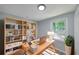 Bright office featuring large window, light wood book shelves, and a comfortable chair at 243 Howell Sw Ter, Atlanta, GA 30331
