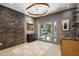 Elegant bar area with textured wall, art, unique lighting, and doors to the outside at 2525 Peachtree Ne Rd # 32, Atlanta, GA 30305