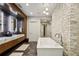 Modern bathroom featuring a soaking tub, dual vanity with marble countertop, and unique textured wall at 2525 Peachtree Ne Rd # 32, Atlanta, GA 30305