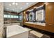 Modern bathroom with marble accents, dual vanity, soaking tub, and glass enclosed shower at 2525 Peachtree Ne Rd # 32, Atlanta, GA 30305