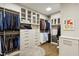 Spacious walk-in closet with custom shelving, drawers, and glass-front cabinets for organized storage at 2525 Peachtree Ne Rd # 32, Atlanta, GA 30305