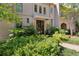 Elegant home entrance with lush greenery, a covered doorway, and a classic black front door at 2525 Peachtree Ne Rd # 32, Atlanta, GA 30305