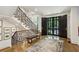 Elegant foyer featuring a staircase with custom railing, unique lighting, and hardwood floors at 2525 Peachtree Ne Rd # 32, Atlanta, GA 30305