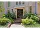 Inviting entryway with a black front door, brick steps, and carefully arranged landscaping at 2525 Peachtree Ne Rd # 32, Atlanta, GA 30305