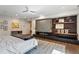 Stylish primary bedroom featuring modern fireplace, shelving, and hardwood floors at 2525 Peachtree Ne Rd # 32, Atlanta, GA 30305