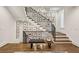 Staircase with wooden steps and black metal railing features decor and bench at 2525 Peachtree Ne Rd # 32, Atlanta, GA 30305