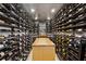 Extensive wine cellar with custom racking and center display table for enthusiasts at 2525 Peachtree Ne Rd # 32, Atlanta, GA 30305