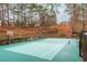 Full tennis court nestled in a wooded backyard setting ready for the next match at 3533 Essex Ave # 77, Atlanta, GA 30339