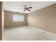Bedroom with plush carpet, neutral walls, and a ceiling fan and window at 1501 Clairmont Rd # 1024, Decatur, GA 30033