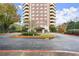 View of the building entrance and covered parking with manicured landscaping at 1501 Clairmont Rd # 1024, Decatur, GA 30033
