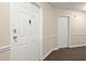 Hallway with neutral paint and carpet leads to apartments, providing a simple yet functional entrance at 1501 Clairmont Rd # 1024, Decatur, GA 30033