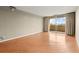 Living room featuring hardwood floors, balcony access, and neutral paint at 1501 Clairmont Rd # 1024, Decatur, GA 30033