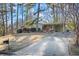 Charming home with a long driveway, mature trees, and brick accents at 2098 Dundee Se Dr, Smyrna, GA 30080