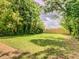Large, grassy backyard framed by mature trees and lush greenery, creating a private outdoor space at 2569 Northview Ave, Decatur, GA 30032