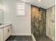 Bathroom featuring a shower with dark tile, a vanity with sink and mirror, and neutral walls at 2569 Northview Ave, Decatur, GA 30032