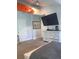 Bright bedroom with a white dresser, flat screen tv, and a mounted kayak above the doorway at 2569 Northview Ave, Decatur, GA 30032