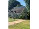 Quaint gray brick home with stone accents and a vibrant blue front door at 2569 Northview Ave, Decatur, GA 30032
