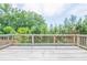 Outdoor deck with wooden planks overlooks green trees and a blue sky at 3540 Lindsy Brook, Douglasville, GA 30135