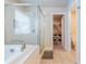 A bathroom suite features a tub, glass enclosed shower and access to a walk-in closet at 3540 Lindsy Brook, Douglasville, GA 30135