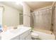 Bathroom with white vanity, tub/shower combo, neutral tile and light fixture at 3540 Lindsy Brook, Douglasville, GA 30135