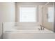 Bright bathroom featuring a large white tub, tile surround and glass enclosed shower at 3540 Lindsy Brook, Douglasville, GA 30135