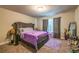Bedroom with gray headboard and purple accents with a window and carpeted floor at 3540 Lindsy Brook, Douglasville, GA 30135