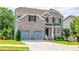 Lovely two-story brick home with a two-car garage and a beautifully maintained front lawn at 3540 Lindsy Brook, Douglasville, GA 30135